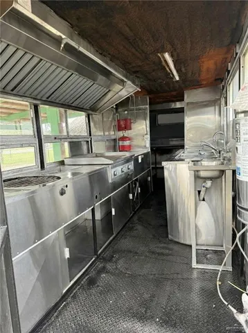 a kitchen with stainless steel appliances granite countertop a sink a stove and a refrigerator