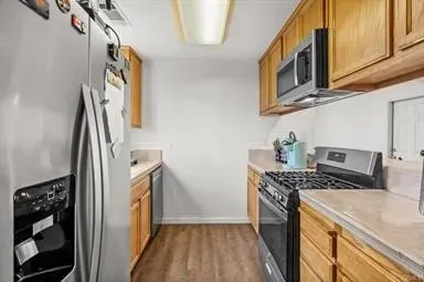 a kitchen with stainless steel appliances granite countertop a stove a sink and a refrigerator