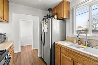 a kitchen with a refrigerator and a sink