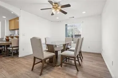 a view of a dining room with furniture window and wooden floor