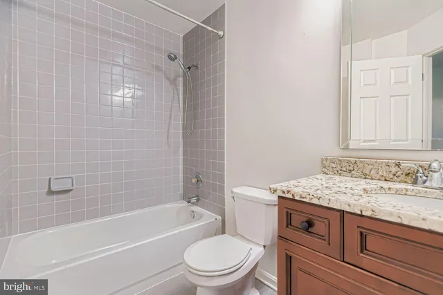 a bathroom with a sink toilet vanity and shower