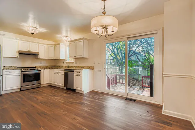 a kitchen with a stove a sink and a refrigerator