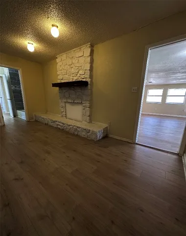 a kitchen with granite countertop a sink and a stove top oven