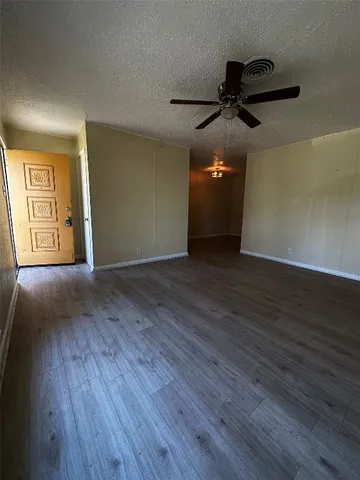 a view of an empty room and wooden floor