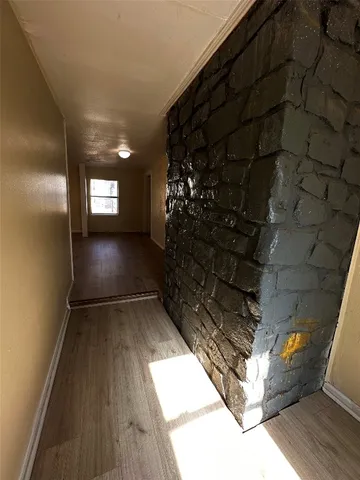a view of a room with wooden floor and windows
