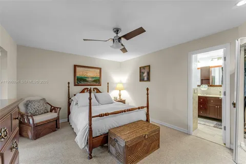 a bedroom with a bed and ceiling fan