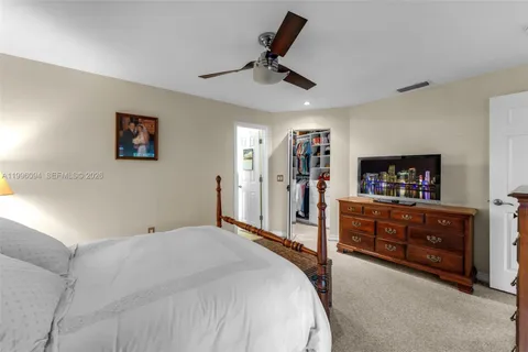 a bed room with a bed and a television