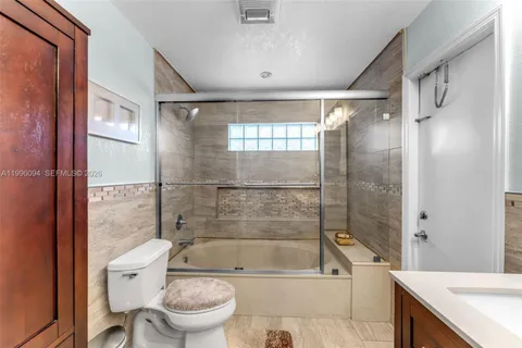 a bathroom with a bathtub toilet and shower