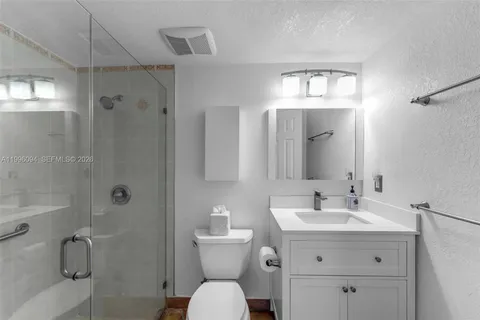 a bathroom with a toilet sink shower and mirror
