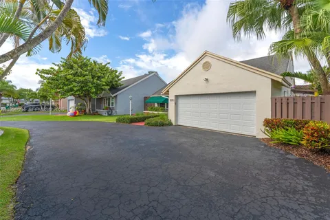 a view of a house with a yard and a garage