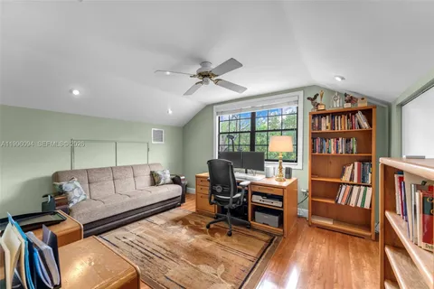 a living room with furniture and a book shelf