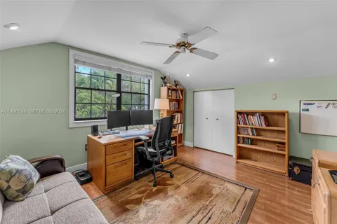 a view of a livingroom with workspace and a window