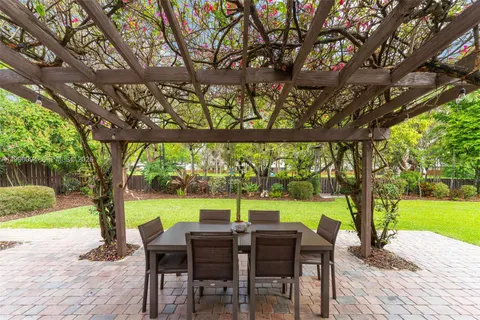 a view of a patio with a table chairs and a backyard