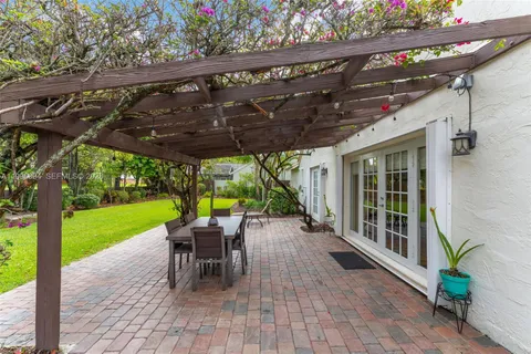 a view of a patio with a table chairs and a backyard