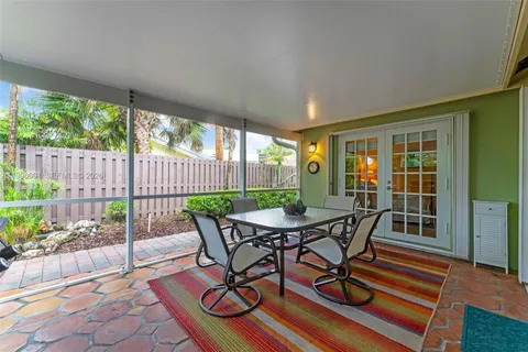 a view of a patio with a dining table and chairs