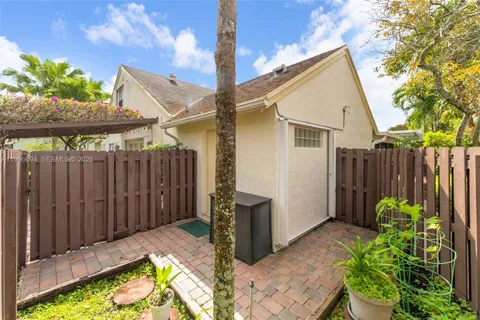 a view of a backyard with wooden fence