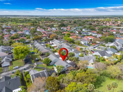 an aerial view of residential houses with outdoor space