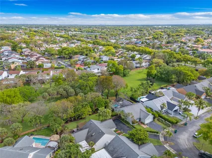 an aerial view of residential building with green space