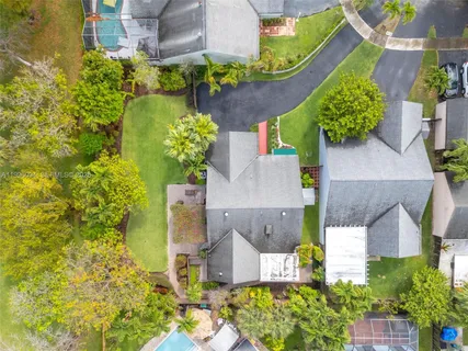 an aerial view of a house with a yard and garden