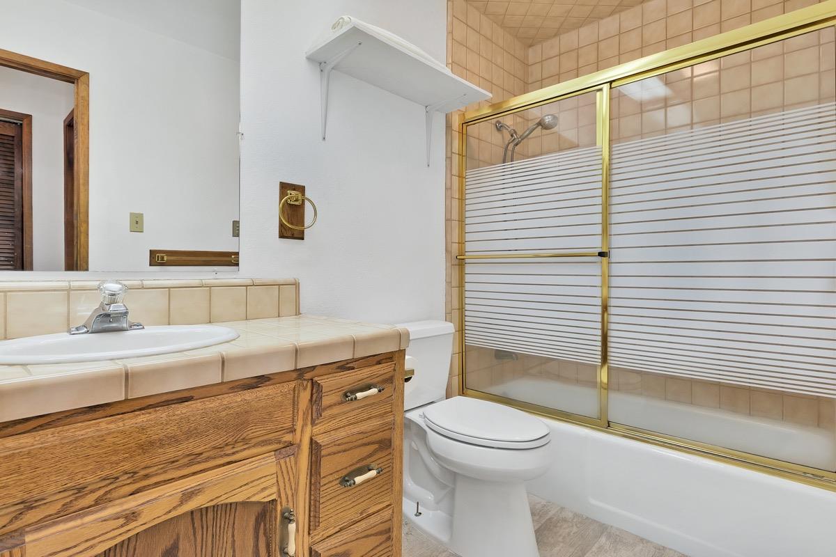 250 Davison Road Mammoth Lakes, CA 93546 - Photo 14 of 30 a bathroom with a granite countertop sink toilet and shower