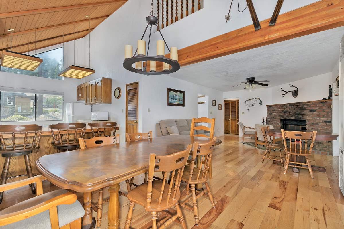 250 Davison Road Mammoth Lakes, CA 93546 - Photo 2 of 30 a dining room with furniture a kitchen and chandelier