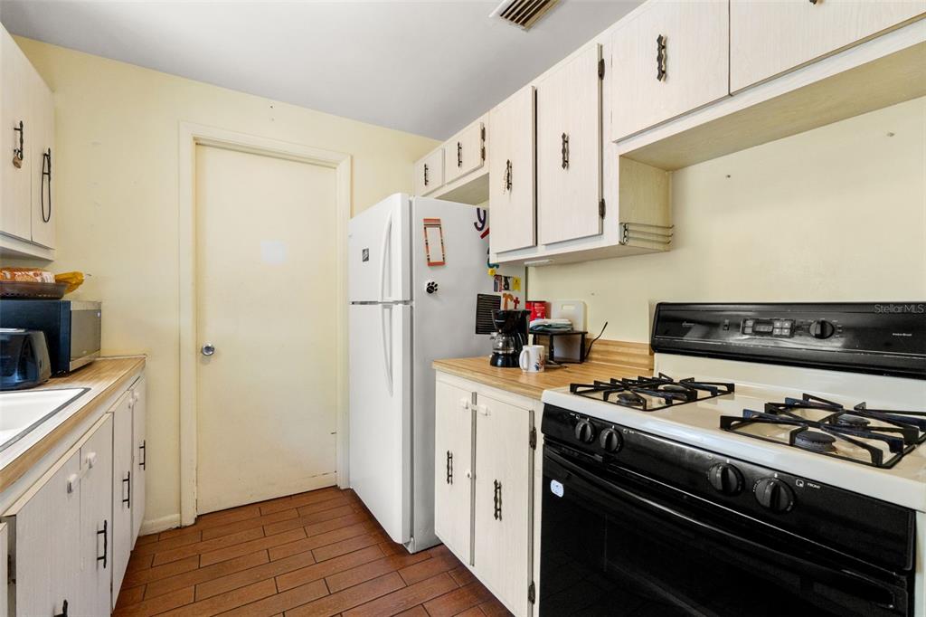 9658 Bayside Court Spring Hill, FL 34608 - Photo 13 of 34 a kitchen with stainless steel appliances a stove a sink and a refrigerator