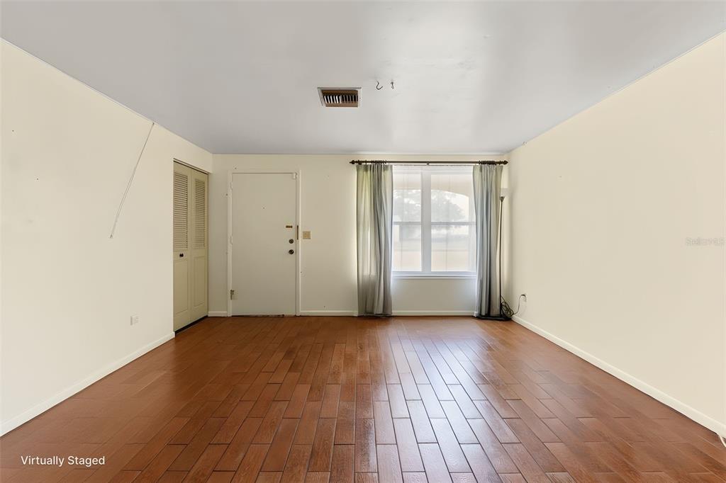 9658 Bayside Court Spring Hill, FL 34608 - Photo 17 of 34 an empty room with wooden floor and windows