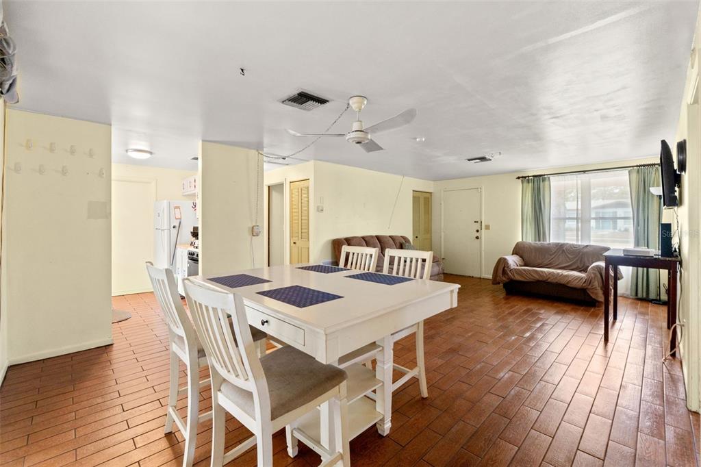 9658 Bayside Court Spring Hill, FL 34608 - Photo 19 of 34 a view of a dining room with furniture and wooden floor