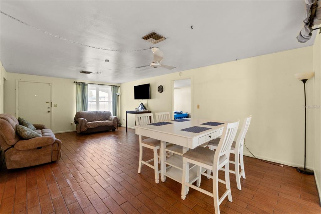 9658 Bayside Court Spring Hill, FL 34608 - Photo 20 of 34 a living room with furniture wooden floor and a fireplace