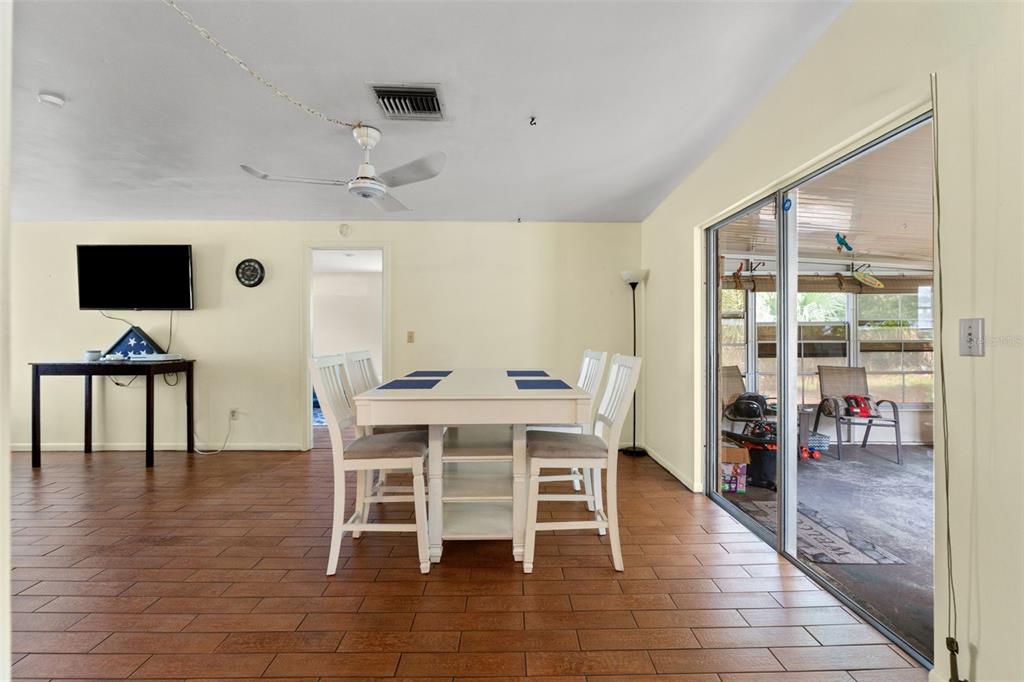 9658 Bayside Court Spring Hill, FL 34608 - Photo 21 of 34 a view of a dining room with furniture window and wooden floor