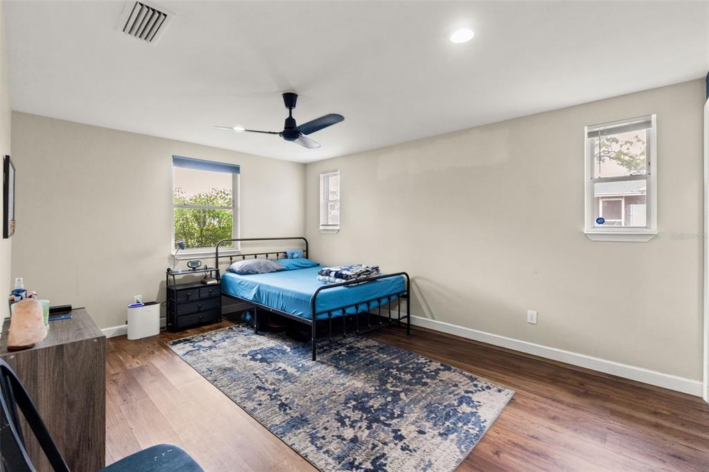 9658 Bayside Court Spring Hill, FL 34608 - Photo 22 of 34 a bedroom with furniture window and wooden floor