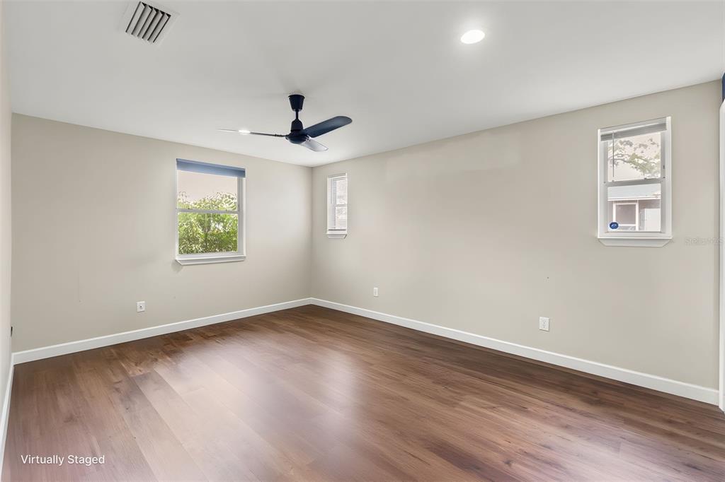 9658 Bayside Court Spring Hill, FL 34608 - Photo 23 of 34 a view of an empty room with a window and wooden floor
