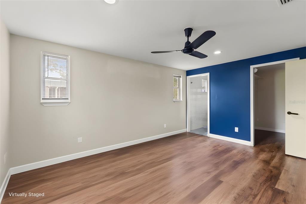 9658 Bayside Court Spring Hill, FL 34608 - Photo 25 of 34 a view of an empty room with wooden floor and a window