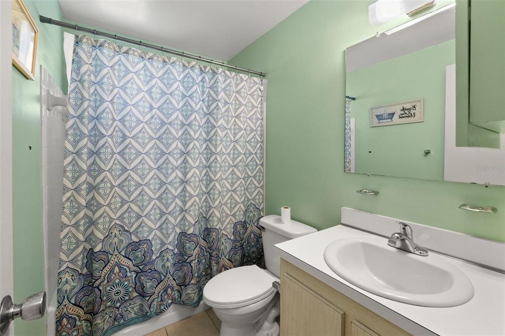 9658 Bayside Court Spring Hill, FL 34608 - Photo 28 of 34 a bathroom with a sink and a mirror