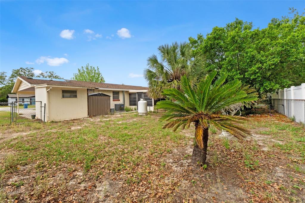 9658 Bayside Court Spring Hill, FL 34608 - Photo 8 of 34 a view of a house with a yard and potted plants