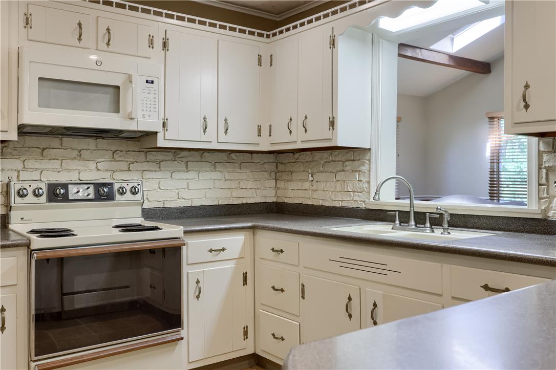 Coldsprings Rd Union Pottstown, PA 19465 - Photo 43 of 71 A well-appointed kitchen features a pass-through window and ample cabinetry, offering both functionality and connection.