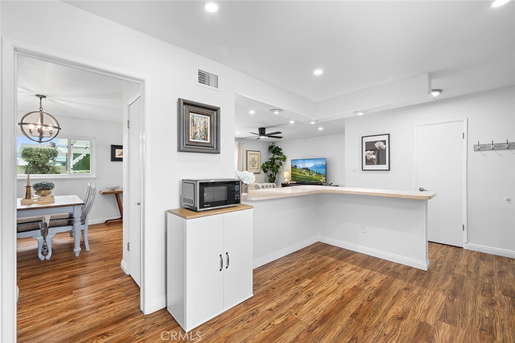 5472 Marion Avenue Cypress, CA 90630 - Photo 14 of 36 a living room with stainless steel appliances kitchen island hardwood floor and a large window