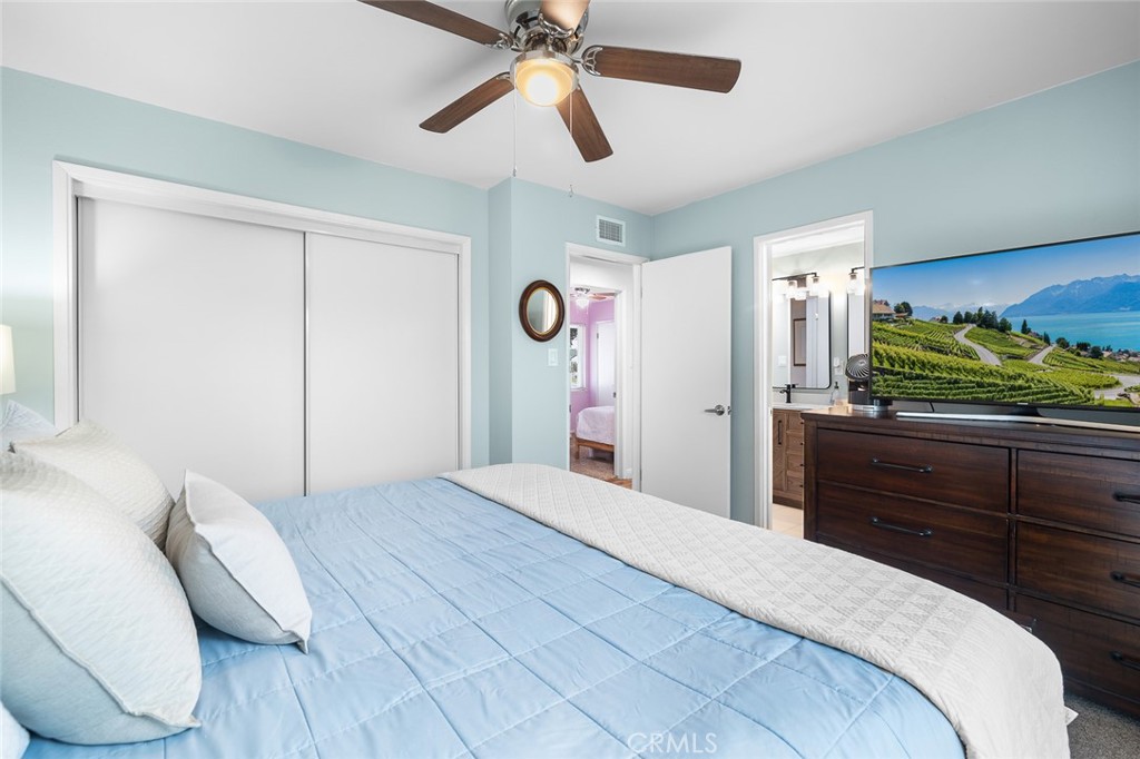 5472 Marion Avenue Cypress, CA 90630 - Photo 19 of 36 a bedroom with a bed and a chandelier