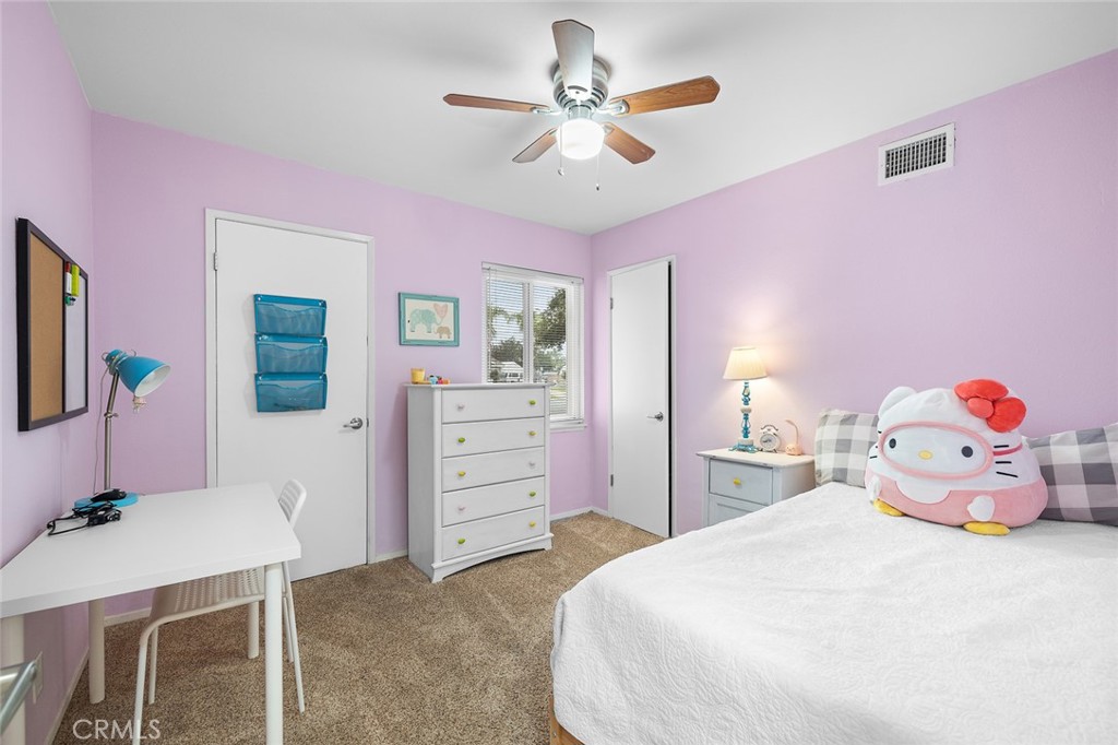 5472 Marion Avenue Cypress, CA 90630 - Photo 21 of 36 a bedroom with a bed and a chandelier