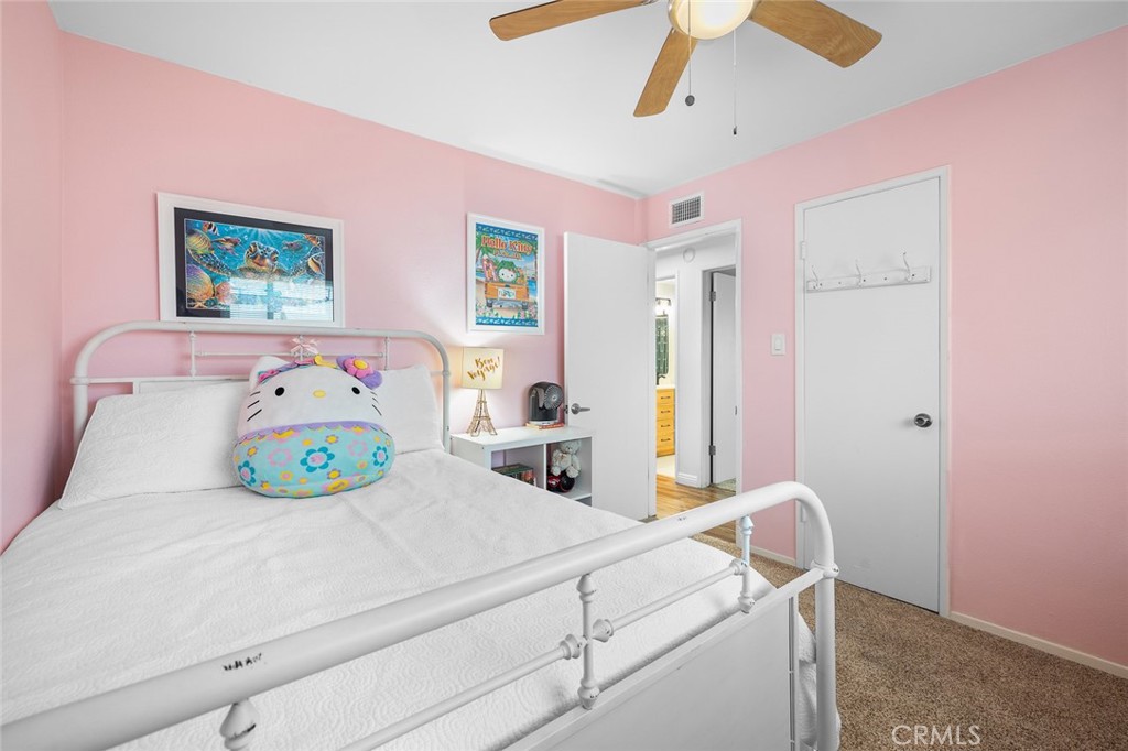 5472 Marion Avenue Cypress, CA 90630 - Photo 24 of 36 a bedroom with a bed next to a window