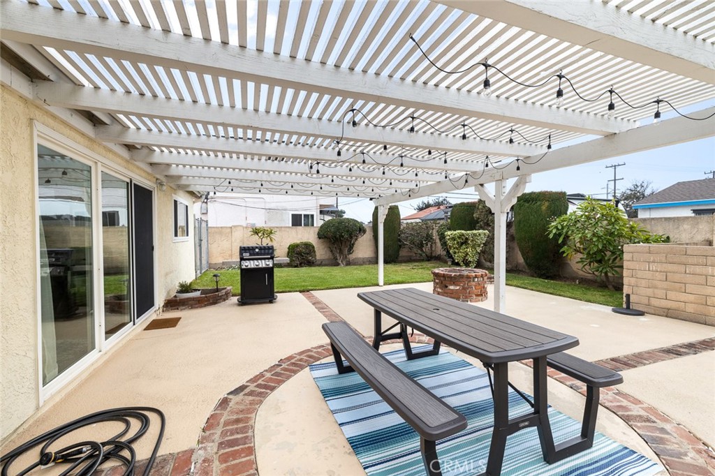5472 Marion Avenue Cypress, CA 90630 - Photo 26 of 36 a view of a patio with a table chairs and a backyard