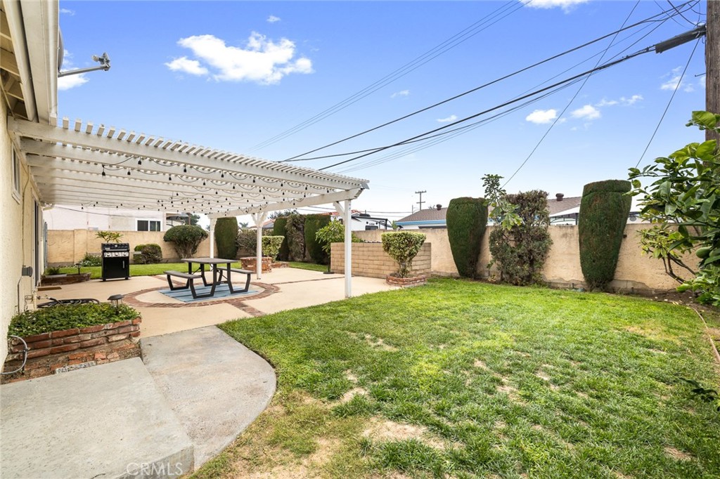 5472 Marion Avenue Cypress, CA 90630 - Photo 27 of 36 a view of a patio with table and chairs potted plants and large tree