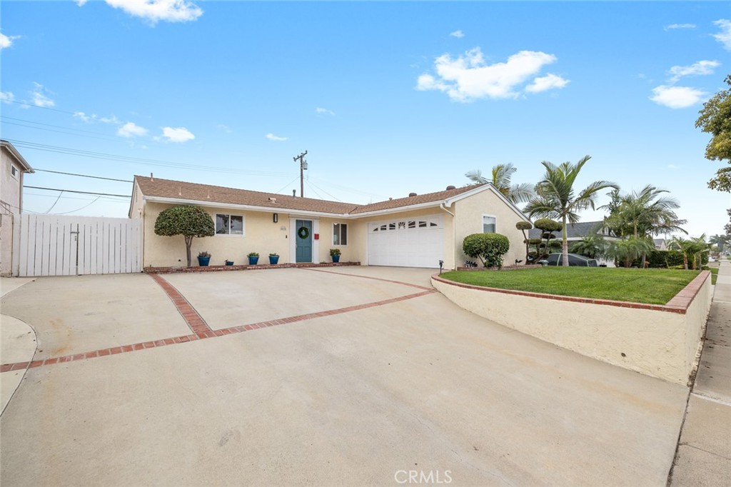 5472 Marion Avenue Cypress, CA 90630 - Photo 34 of 36 a view of a white house with a yard and potted plants