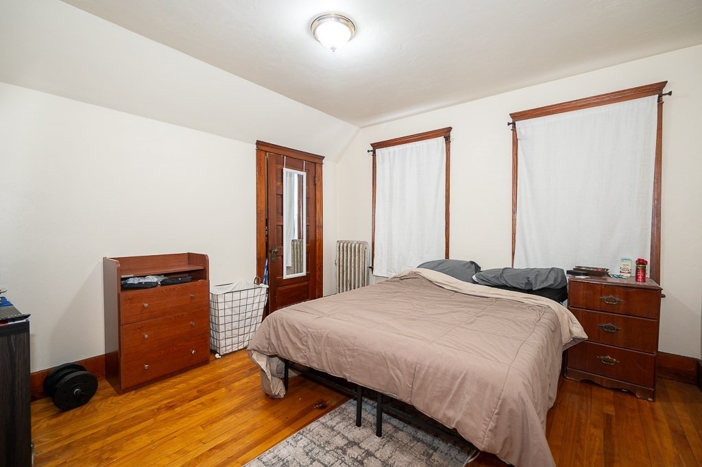 104 1/2 Rodney Street Worcester, MA 01605 - Photo 7 of 25 a bedroom with a bed and two windows