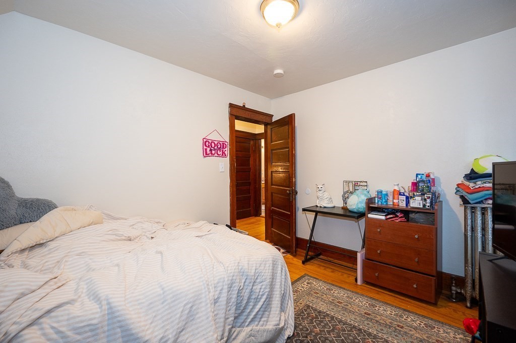 104 1/2 Rodney Street Worcester, MA 01605 - Photo 8 of 25 a bedroom with a bed and a desk