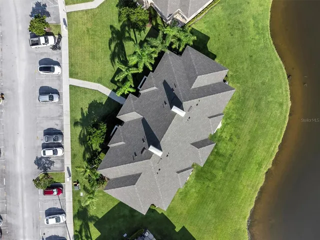 an aerial view of a house with a yard
