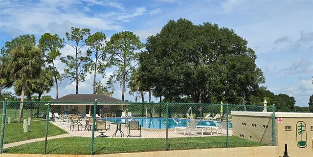 a patio with a table and chairs under an umbrella