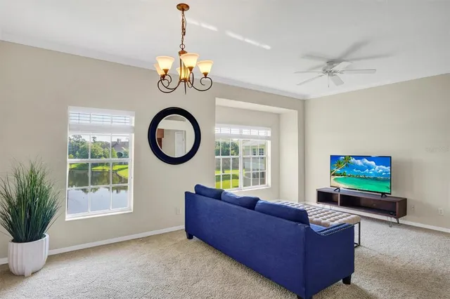 a living room with furniture a window and a flat screen tv