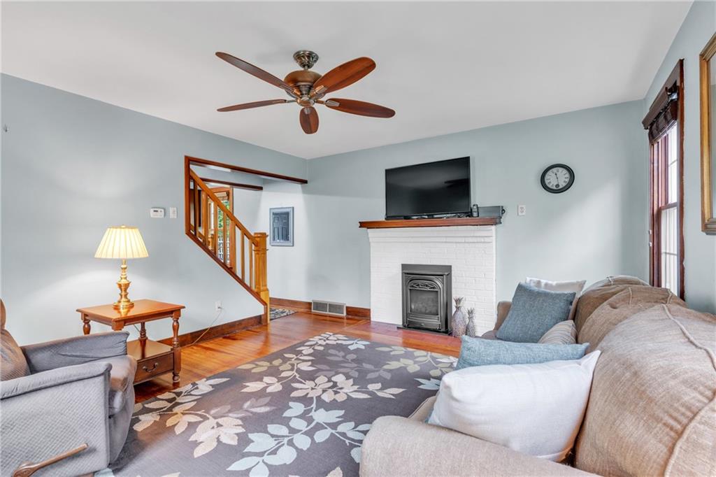 461 Manor Road Wexford, PA 15090 - Photo 11 of 43 a living room with furniture a fireplace and a flat screen tv