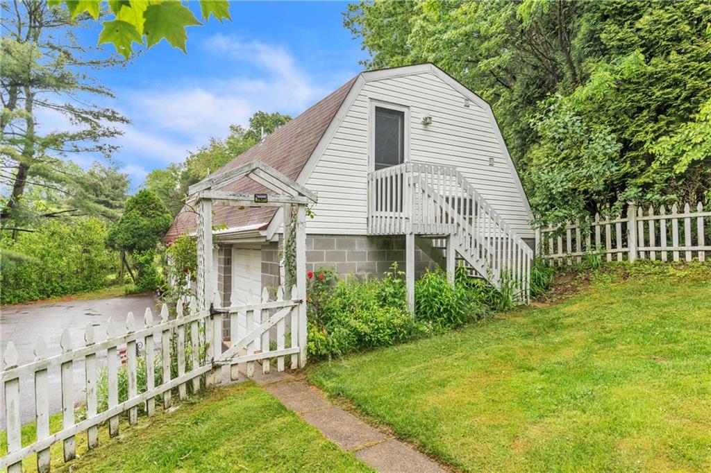 461 Manor Road Wexford, PA 15090 - Photo 22 of 43 a view of a house with brick walls and a yard with plants